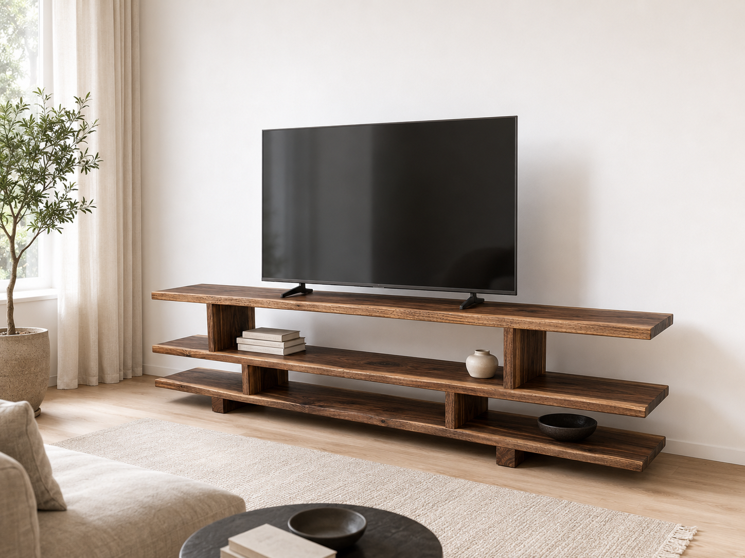 Extra-long solid wood TV stand beneath a large television in a living room